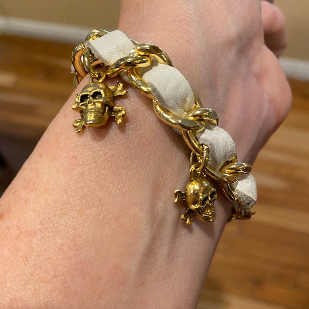 Gold and white leather skull and crossbones bracelet